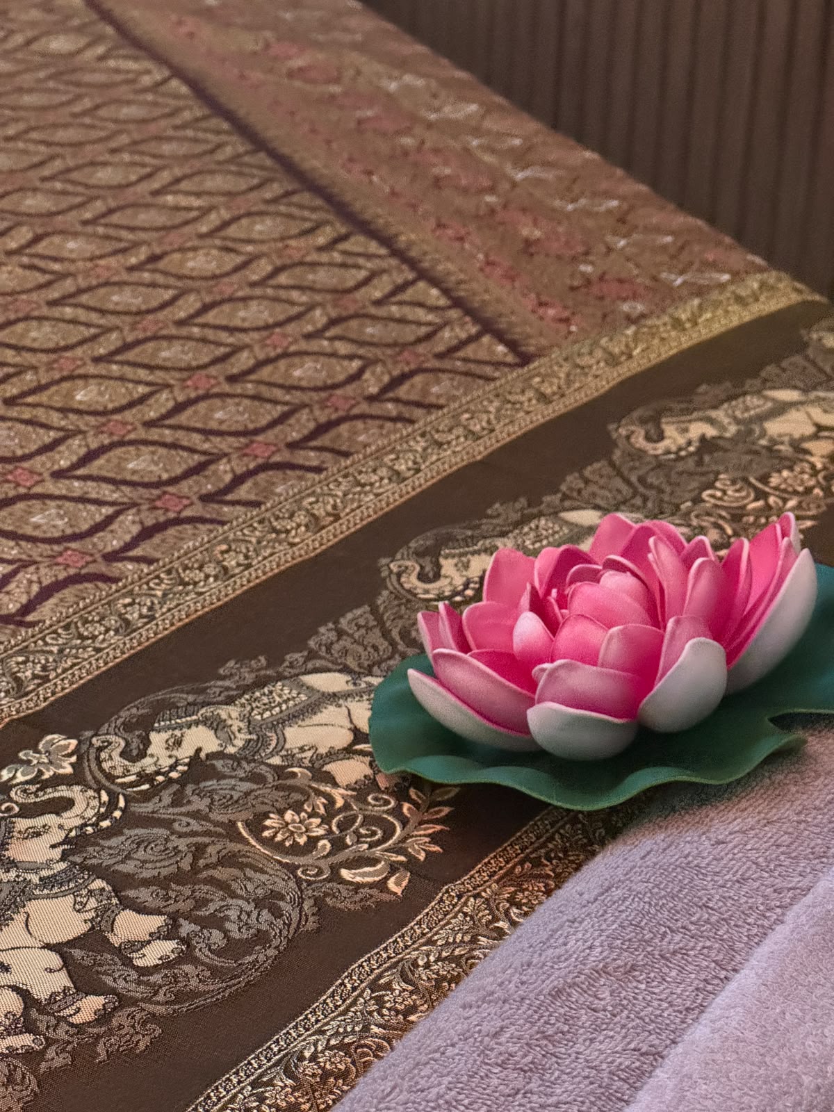 Pink lotus flower on traditional Thai massage fabric