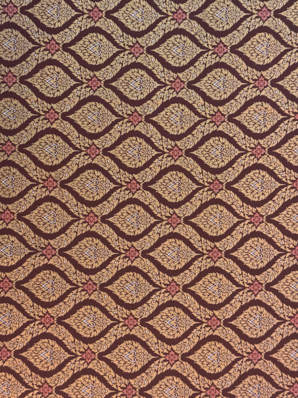 Traditional Thai silk fabric pattern on massage table