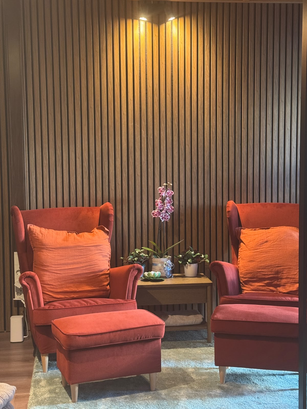 Siam Spa cosy waiting area with warm lighting and red armchairs