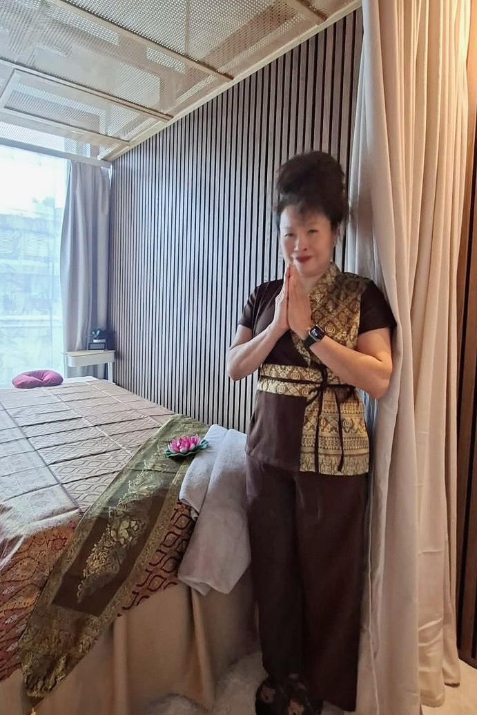 Siam Spa therapist in traditional Thai attire welcoming guests
